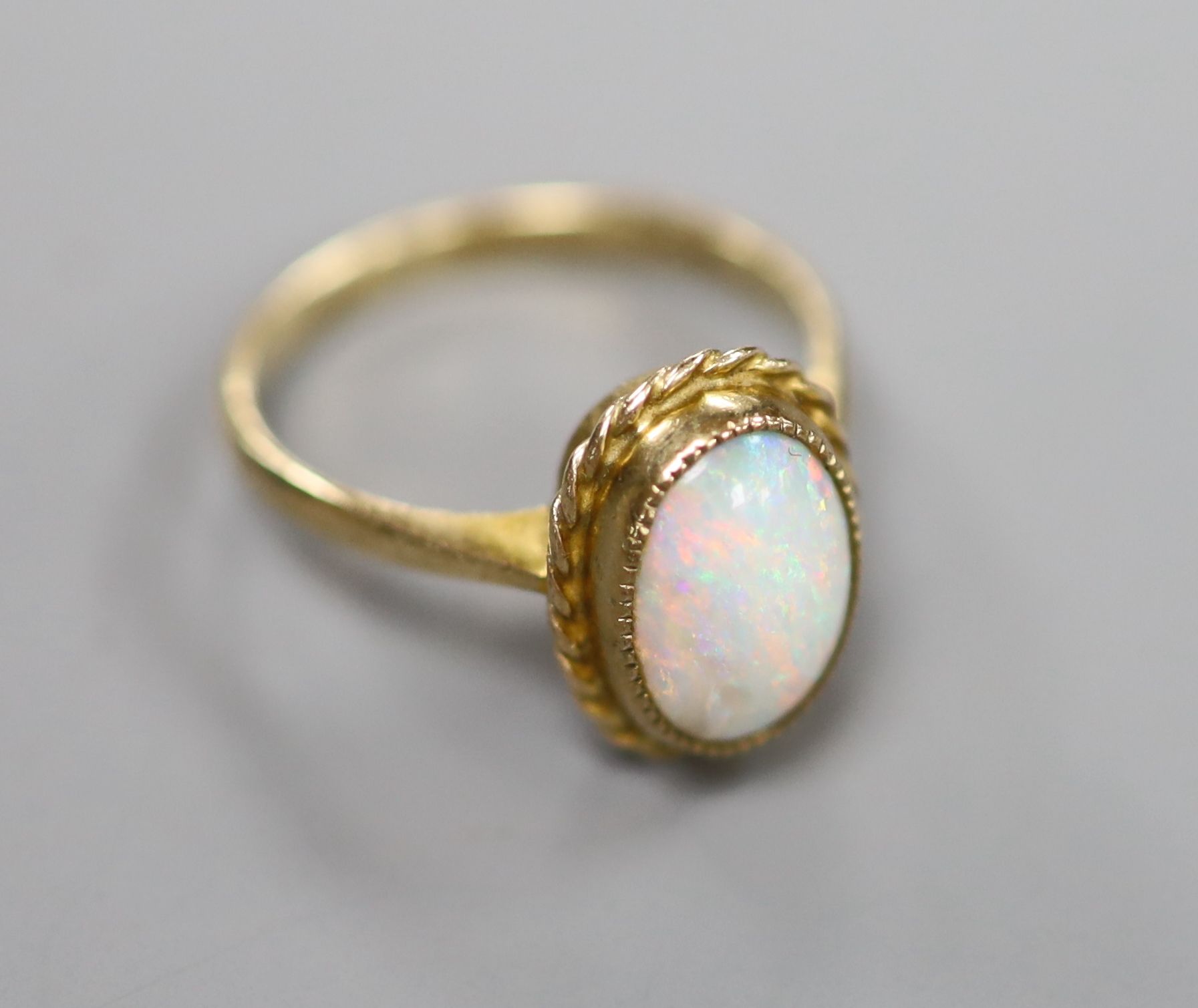 A 9ct and oval white opal set dress ring, size K,